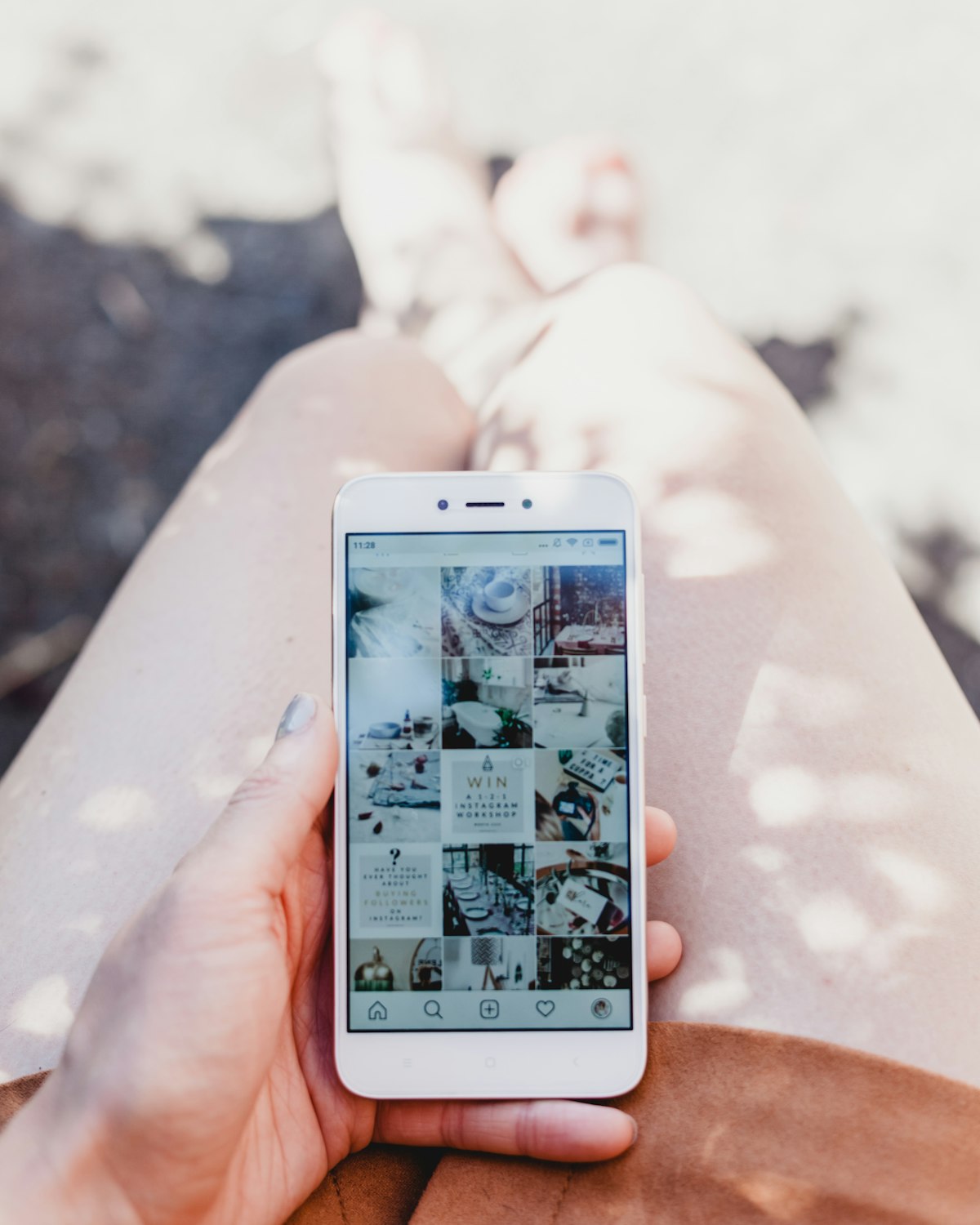 Person holding smartphone showing Instagram feed, representing social media link management and bio-link functionality